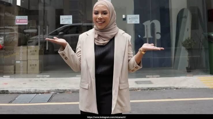 Singapore entrepreneur Miza Nazili stands in her corporate headquarters following her business success.