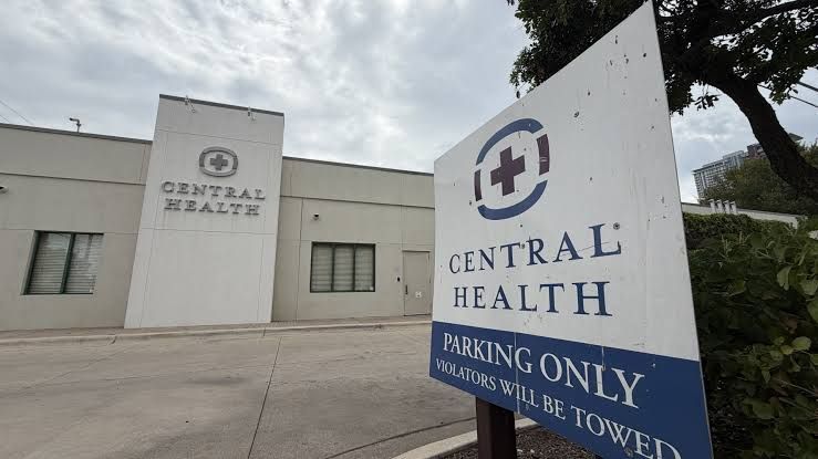 A sign outside a government building in Austin, Texas, detailing upcoming tax hearings and public health board meetings.