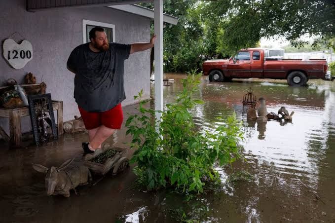 Emergency crews use a rescue boat to navigate flooded streets in the Texas Hill Country following heavy rainfall.