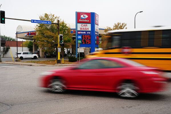 Digital price display at a gas station showing $4.14 for regular gas and $5.85 for diesel.