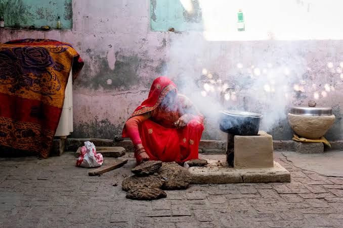 Cooking fuel canisters in a rural Indian village setting, highlighting domestic energy infrastructure.