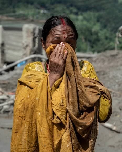 Emergency workers search through thick mud and debris in Bidur after a massive glacier collapse in Nepal.