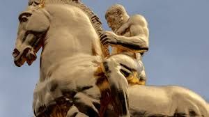 The regilded gold Arts of War horse statue stands on a granite pedestal near the Lincoln Memorial in Washington, D.C.