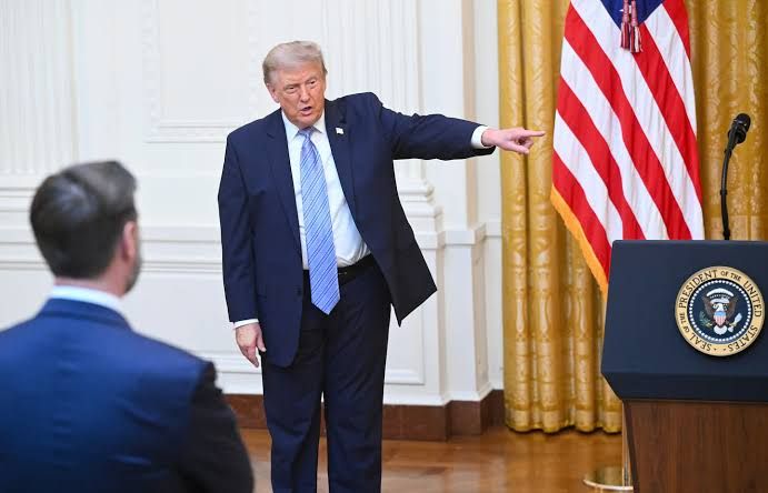 President Donald Trump gestures while speaking in the East Room of the White House during a prime-time address.