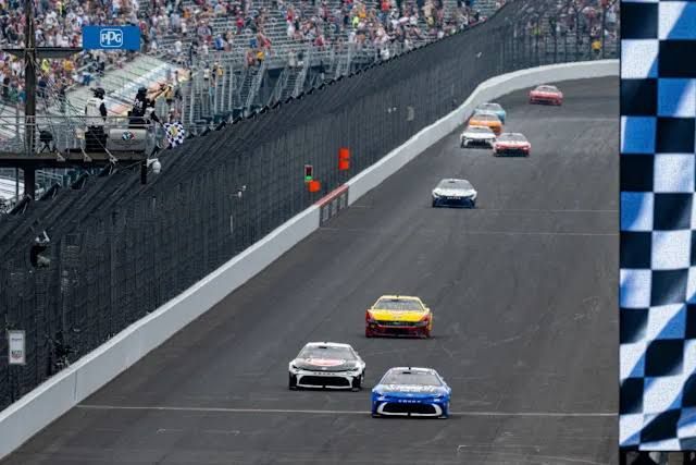 Corey Heim celebrates his Brickyard 400 victory at Indianapolis Motor Speedway while NASCAR drivers voice car complaints.
