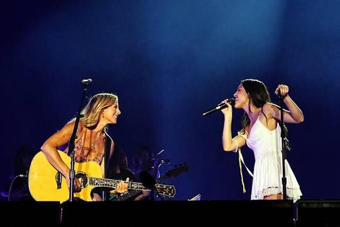Olivia Rodrigo and Sarah McLachlan perform together on stage at the Daisy Chain Fields festival in Irvine.