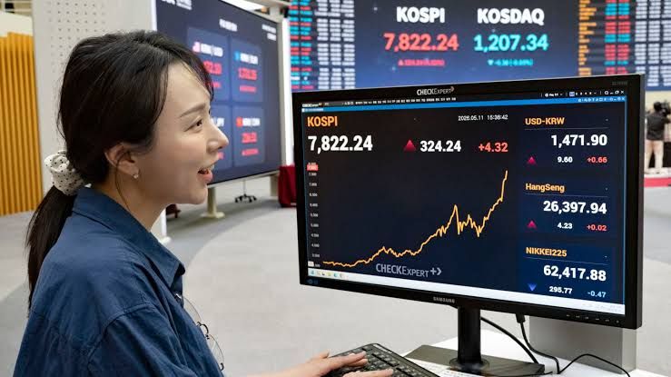 A Korea Exchange employee monitors stock market data on computer screens in the Seoul financial district.