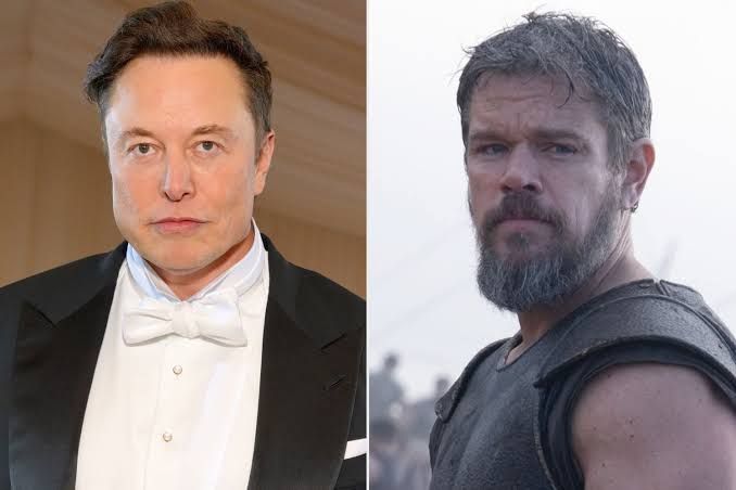 Elon Musk pictured in New York alongside a promotional image of Matt Damon in The Odyssey film.