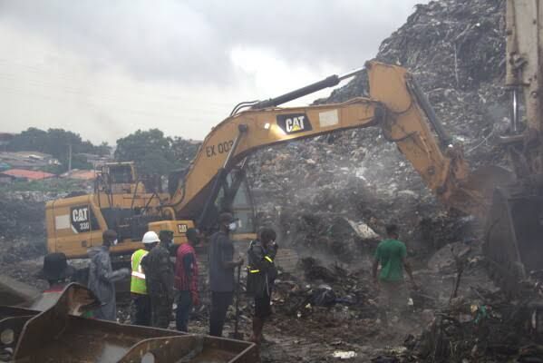 Rescue workers searching for survivors in the debris of the collapsed Dar Es Salam landfill in Conakry, Guinea.