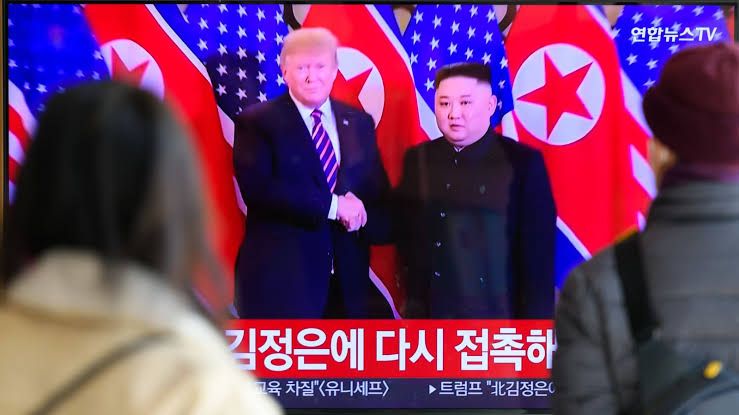 A news broadcast at Seoul Railway Station displays file footage of President Donald Trump and Kim Jong Un.