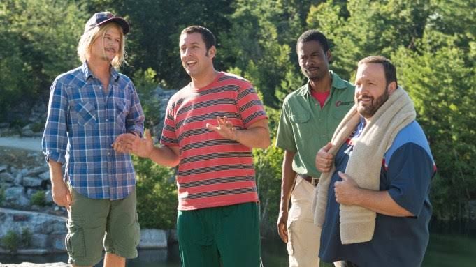 Adam Sandler and original cast members sitting at a restaurant table during production of Grown Ups 3.