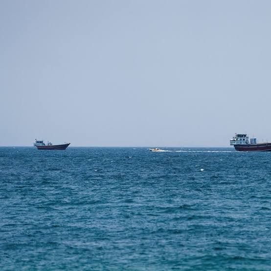 Commercial oil tankers navigating the Strait of Hormuz during international maritime monitoring operations.