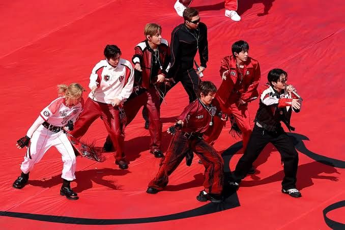 BTS performing on the pitch at New York New Jersey Stadium during the 2026 FIFA World Cup final halftime show.
