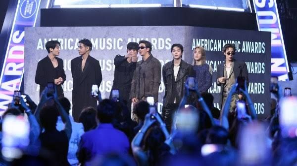 Members of BTS speaking on stage during the 52nd American Music Awards at MGM Grand Garden Arena.