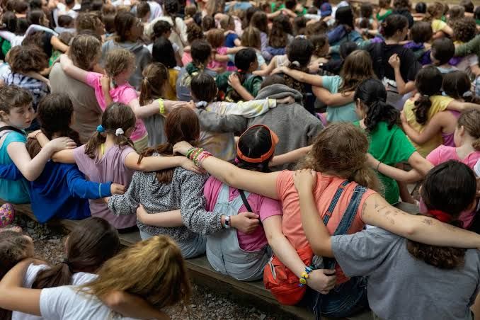 Photographer Rachel Wisniewski holds her new book L'dor Vador, a photo project about girls at a Jewish summer camp.
