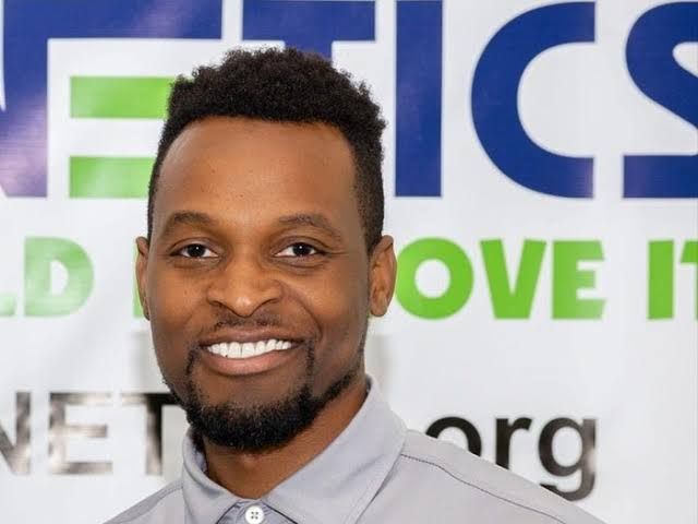 Seun Phillips, founder of Stemnetics, stands in a classroom environment.