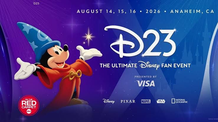 Disney enthusiasts walking through the expansive D23 convention show floor in Anaheim filled with branded displays.
