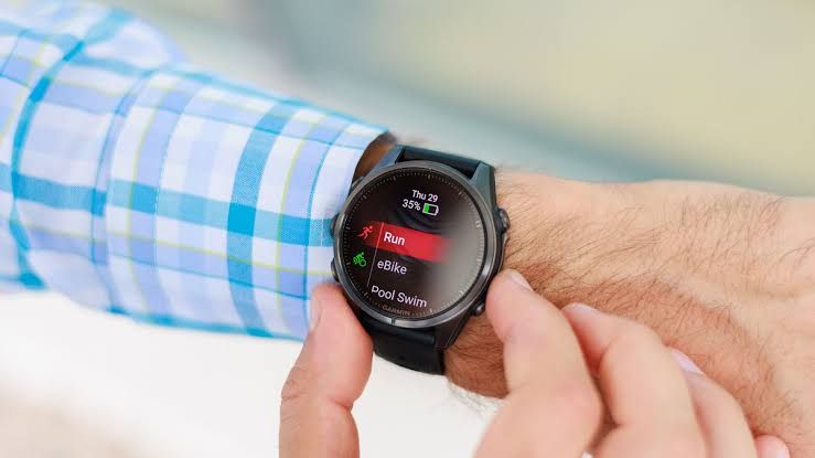 The Garmin Fenix 8 smartwatch displaying a fitness tracking interface on its AMOLED screen.