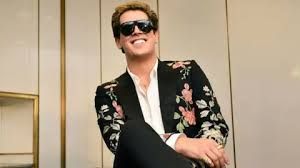 Milo Yiannopoulos wearing a black shirt in a mugshot released by the Department of Homeland Security.