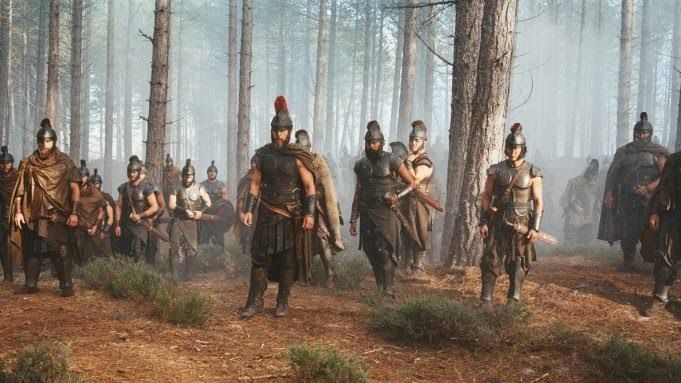 Cast members of The Odyssey standing together on set during the production of the Christopher Nolan film.