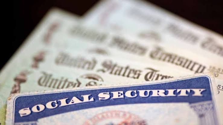 A close-up of a Social Security card on a wooden table, representing government retirement benefit documents.