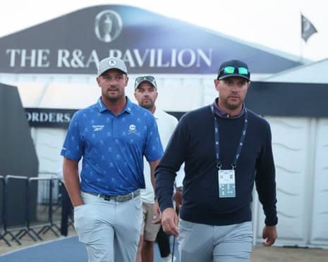 Bryson DeChambeau and agent Brett Falkoff walk to the driving range at Royal Birkdale after receiving a two-stroke penalty.