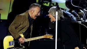 Bruce Springsteen and Jon Bon Jovi performing on stage together at Madison Square Garden in New York City.