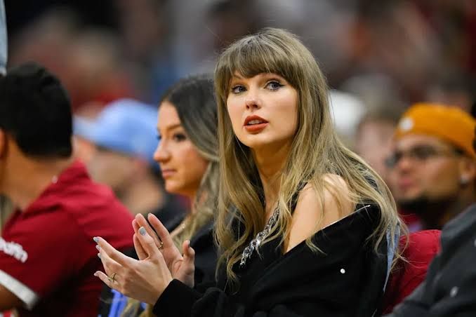 Taylor Swift and Travis Kelce standing together during their wedding ceremony at Madison Square Garden.
