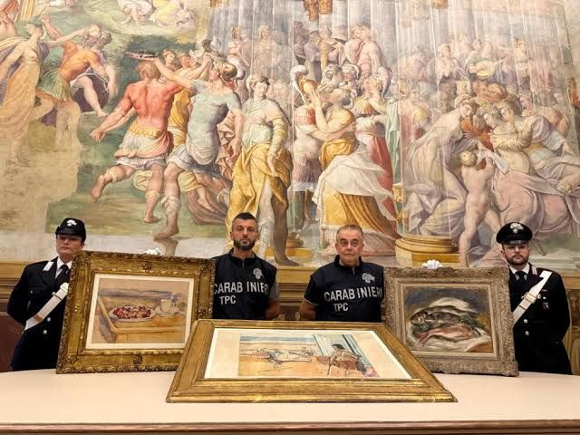 Italian Carabinieri pose with three recovered paintings by Renoir, Cézanne, and Matisse in Parma.