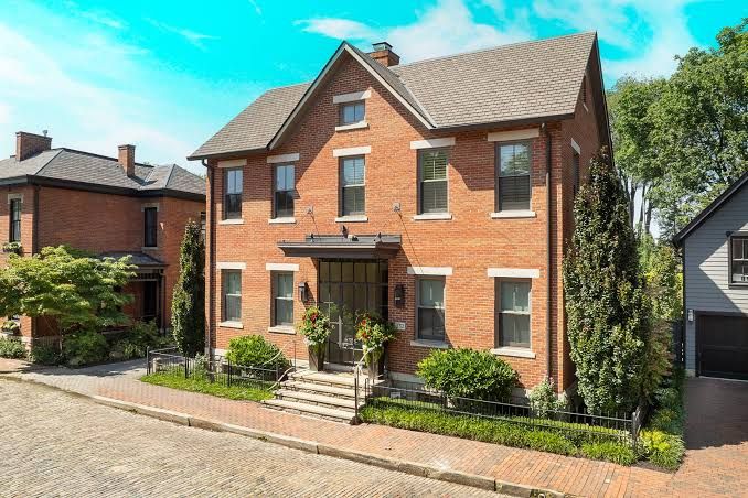 Modern three-story brick house with large windows and a rooftop deck on East Beck Street in German Village.