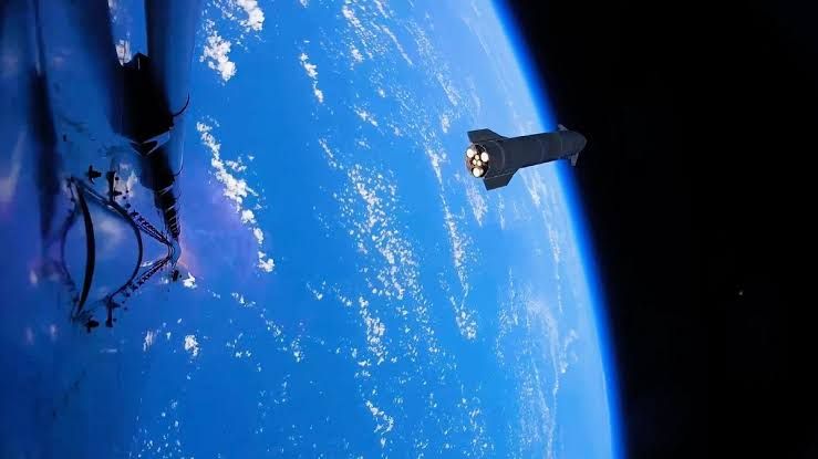 SpaceX Starship rocket lifting off from the launch pad during a test flight at the Starbase facility.