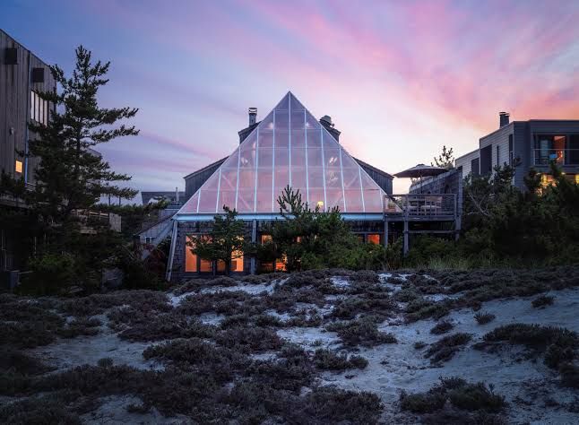 The glass and steel Pyramid House at 443 Sail Walk sits among the sand dunes on Fire Island.