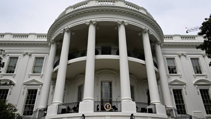 U.S. flag flying above a building, representing the recent implementation of trade tariffs.