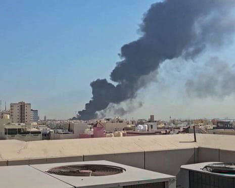 A black smoke plume rises over the town of Mangaf, Kuwait, following Iranian missile strikes.