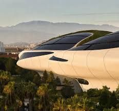 Ma Yansong speaking at an architectural event in front of renderings of the Lucas Museum of Narrative Art in Los Angeles.