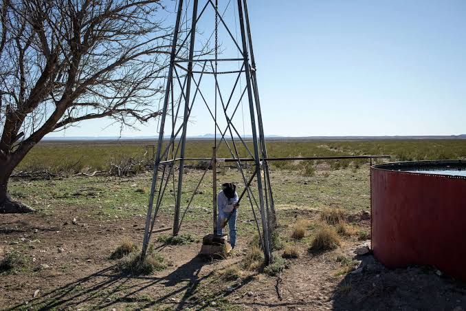 A rancher adjusts a water storage tank on a ranch near Fort Stockton amid concerns over groundwater depletion.