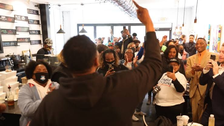 Supporters of Andre Dickens at a rally inside BUZZ Coffee and Winehouse in Atlanta during the 2021 mayoral campaign.