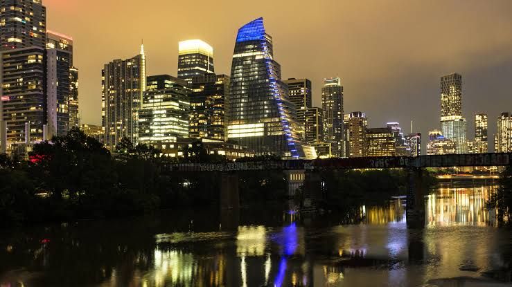 Aerial view of the Austin, Texas city skyline during the day near the Colorado River.