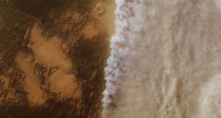 A global dust storm obscuring the surface of Mars as seen from orbit by a satellite.
