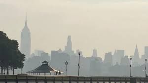 Commuters at Hoboken Terminal navigating through thick wildfire smoke haze on July 17.