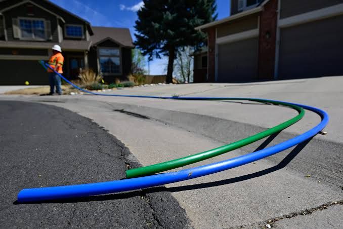 A stylized graphic showing the Boulder Daily Camera logo alongside an illustration of a fiber optic cable.