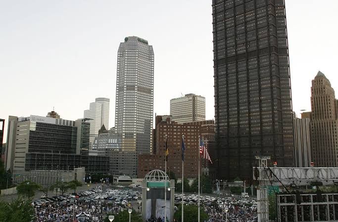 Fans watch a hockey game on a large outdoor screen outside the Pittsburgh arena during the 2009 playoffs.