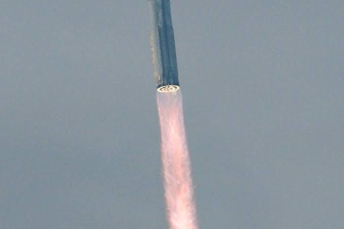 SpaceX Starship rocket lifting off from a launch pad at Starbase in Boca Chica, Texas.