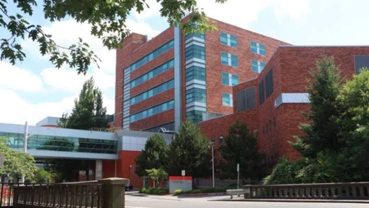 An Oregon hospital exterior building sign at the entrance to an emergency department facility.