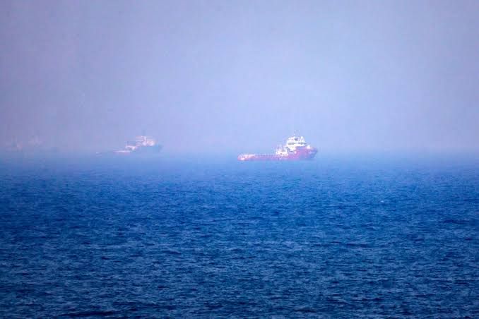 Cargo ships navigating the Strait of Hormuz waters during the ongoing US-Iran conflict in July 2026.