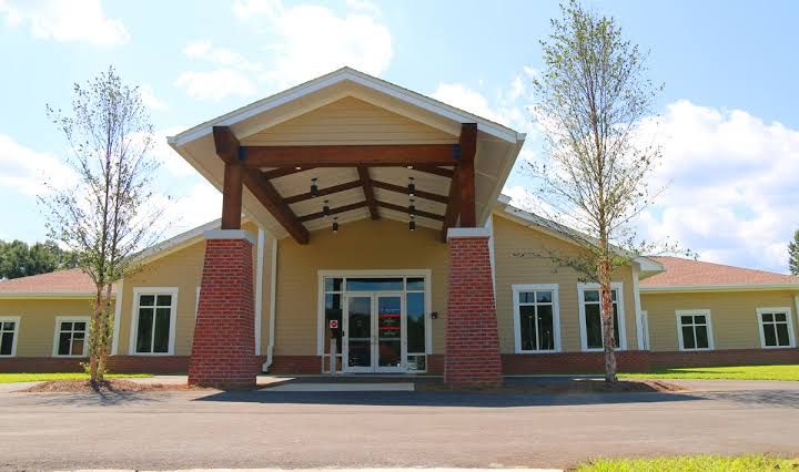Signage for a Community Health Northwest Florida clinic location providing primary and pediatric care services in Century.
