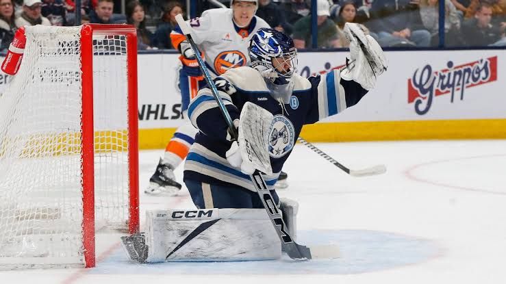 Goaltender Jet Greaves in his Columbus Blue Jackets uniform during a professional hockey game.