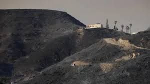 Burnt hillside and a single house remaining after the Almería province wildfires in Spain.