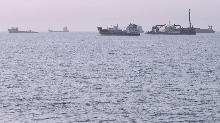 Commercial cargo ships anchored off the coast of Bandar Abbas, Iran, near the Strait of Hormuz.