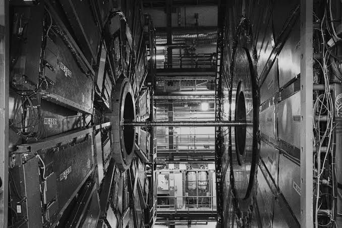 The Large Hadron Collider control room showing complex scientific monitors and equipment in a professional setting.